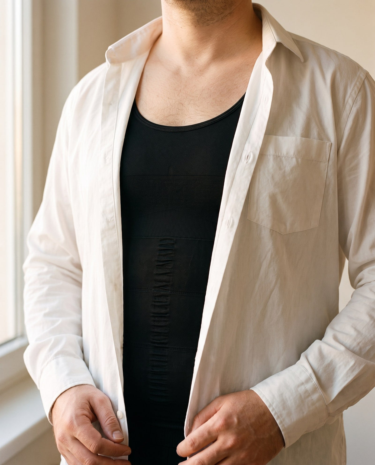 The tank worn under an open white shirt